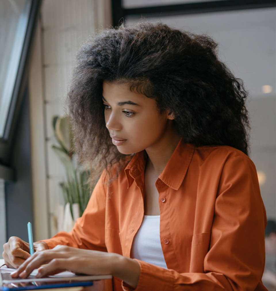 Woman taking a test. Advisor Plus online learning for exams.
